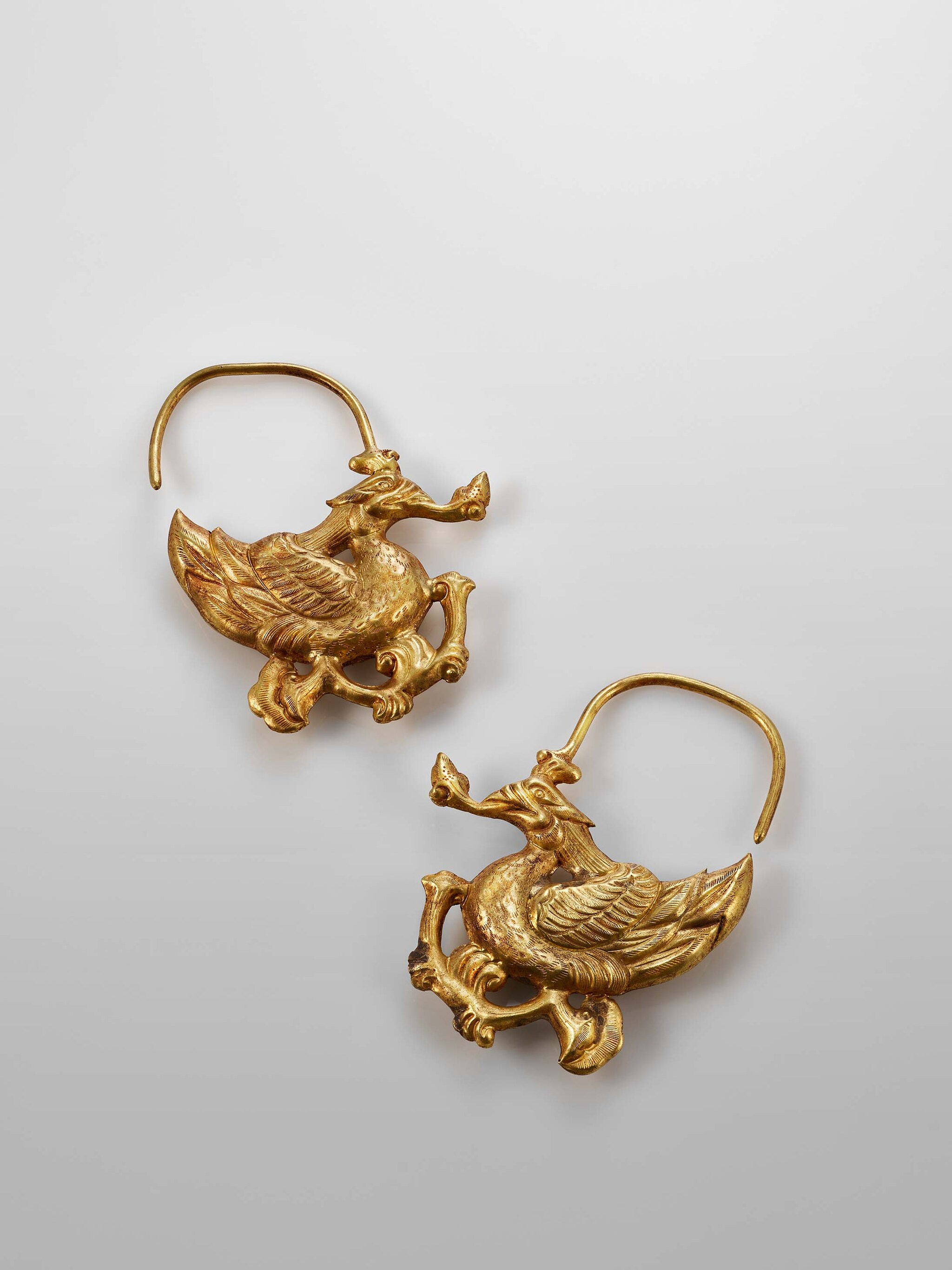 Pair of gold phoenix-shaped earrings, Liao Dynasty, 907-1125, Courtesy of the Mengdiexuan Collection. Photo Picspark Co