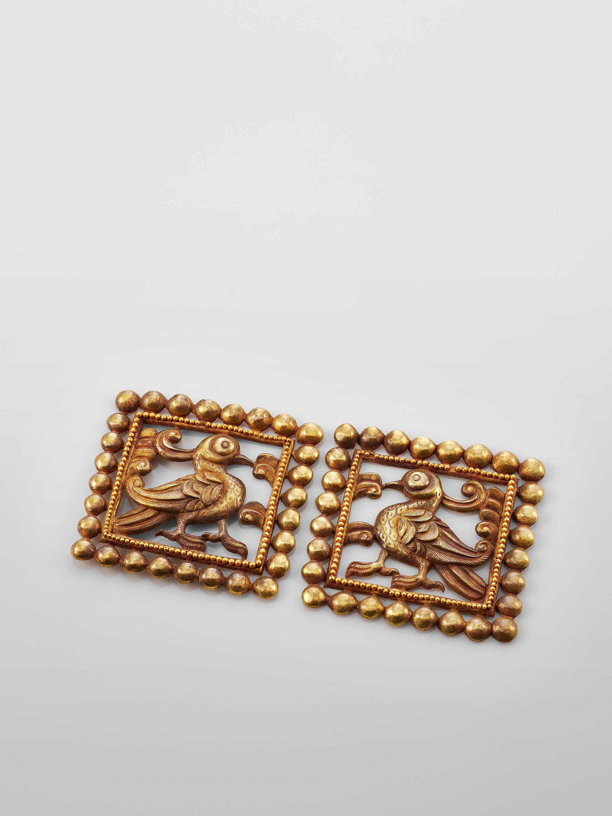 Square openwork gold plaques with bird motifs, 7th to 9th century, Courtesy of the Mengdiexuan Collection. Photo Picspark Co