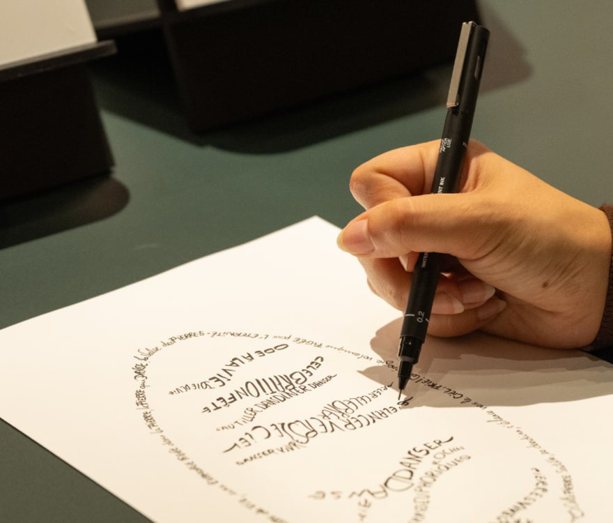 Focus on someone drawing a calligram