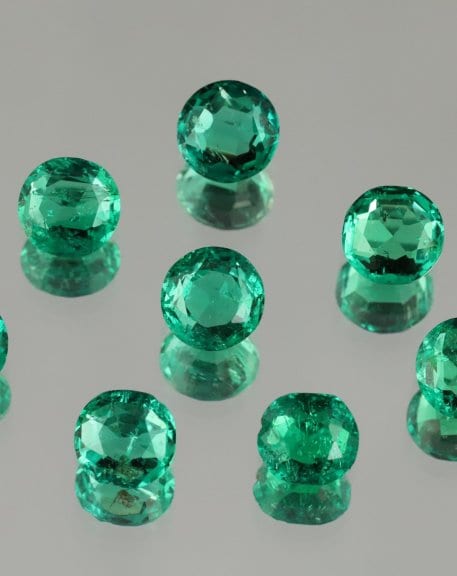 Eight cut emeralds (ranging from 0.854 to 1.339 ct) formerly mounted on the Coronation Crown created by Lemonnier in 1855 (ENSMP 69866). Photo Eloïse Gaillou © Collection of the Paris School of Mines Mineralogy Museum