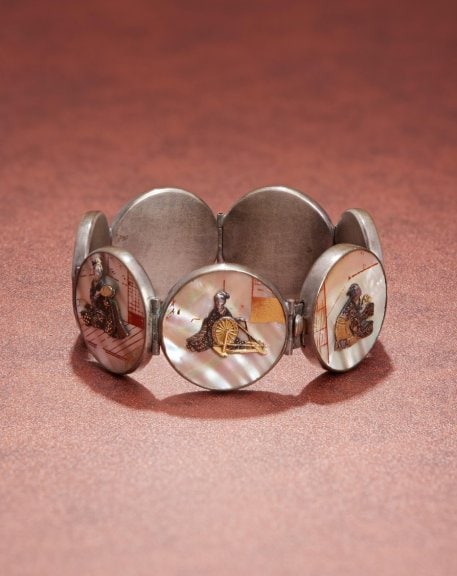 Bracelet with male and female figures playing musical  instruments Japan, late 1800s Gilt shakudo and shell, possibly painted with maki-e lacquer Private Collection