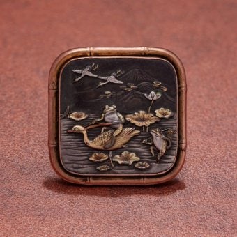 Brooch with frogs in a water lily pond