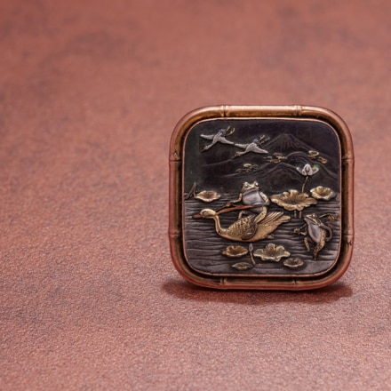 Brooch with frogs in a water lily pond, Japan, late 1800s, gold and silver-gilt shakudo.