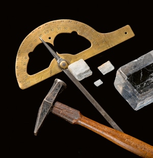 Goniometer, hammer, and rhombohedral calcite crystals, Paris, Musée de Minéralogie