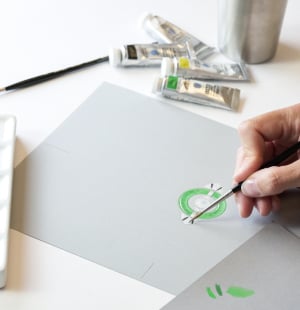 Someone is drawing a jewel on a paper
