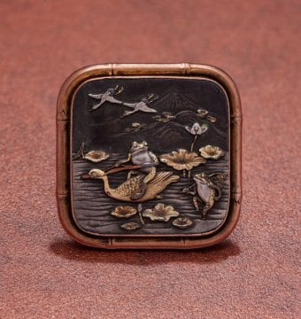Brooch with frogs in a water lily pond